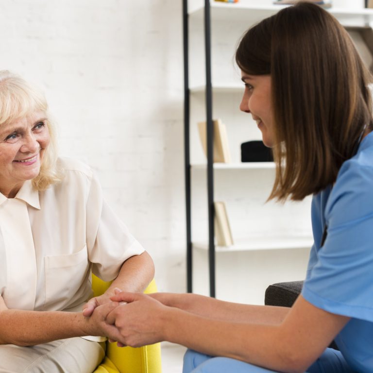 medium-shot-old-woman-nurse-holding-hands